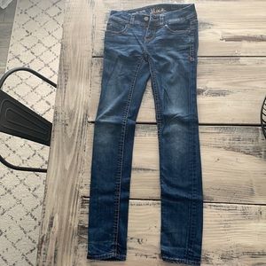 Buckle black skinny jeans